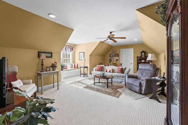 living room featuring ceiling fan, light colored carpet, and lofted ceiling