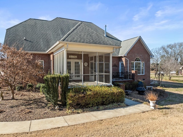 rear view of property featuring a sunroom