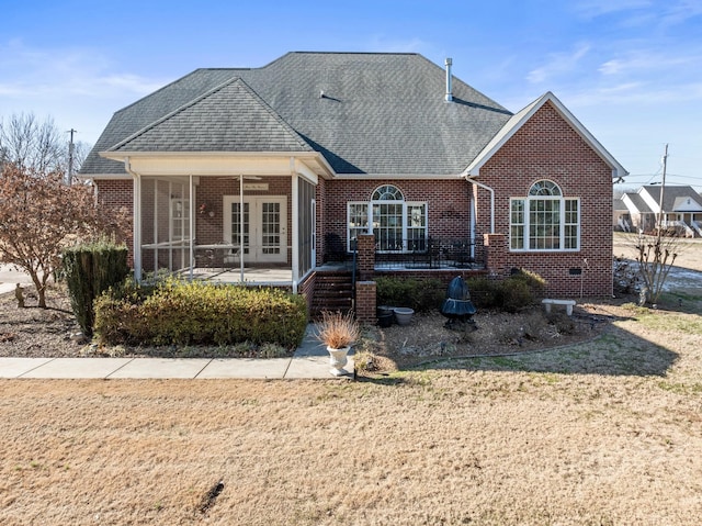 view of front facade with a front lawn and french doors