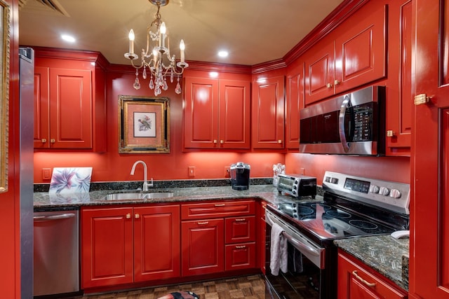 kitchen featuring stainless steel appliances, dark stone counters, a chandelier, pendant lighting, and sink