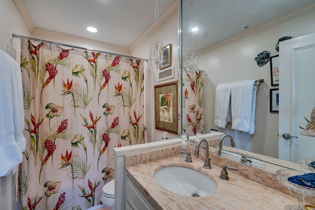 bathroom featuring toilet, vanity, and ornamental molding