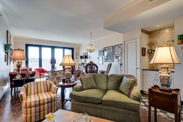 living room with dark parquet floors, a notable chandelier, and crown molding