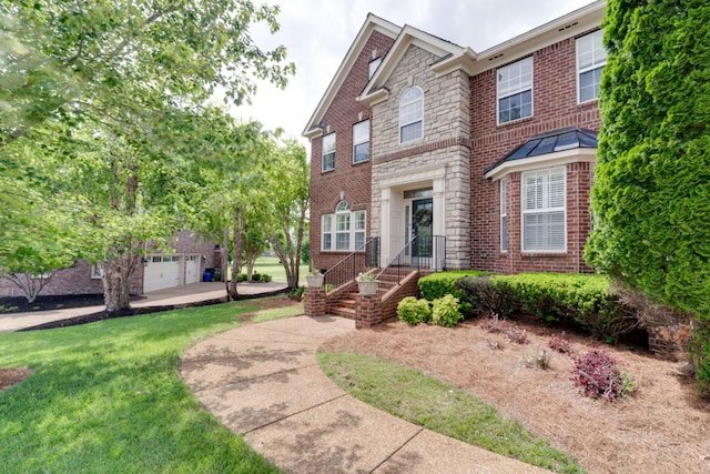 view of front of property featuring a front yard and a garage