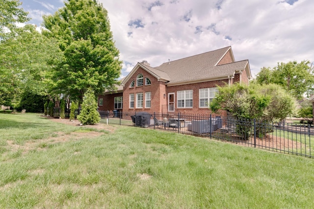 rear view of property featuring a lawn