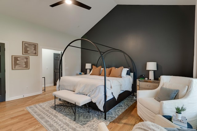 bedroom with ceiling fan, wood-type flooring, and vaulted ceiling