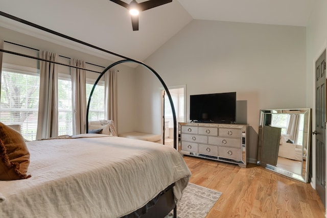 bedroom with ceiling fan, light hardwood / wood-style floors, and lofted ceiling