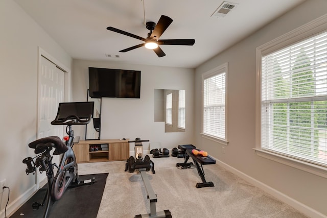 workout area with ceiling fan and carpet