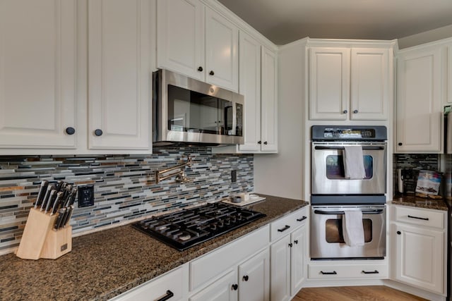 kitchen with stainless steel appliances and white cabinetry