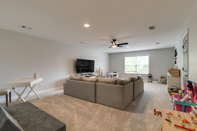 carpeted living room with ceiling fan