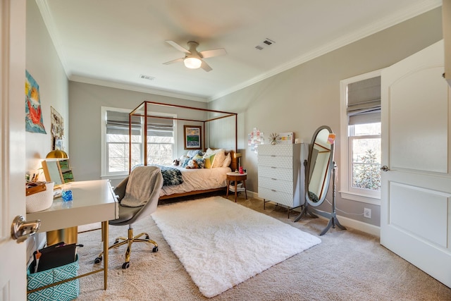 bedroom featuring ceiling fan, multiple windows, crown molding, and carpet floors