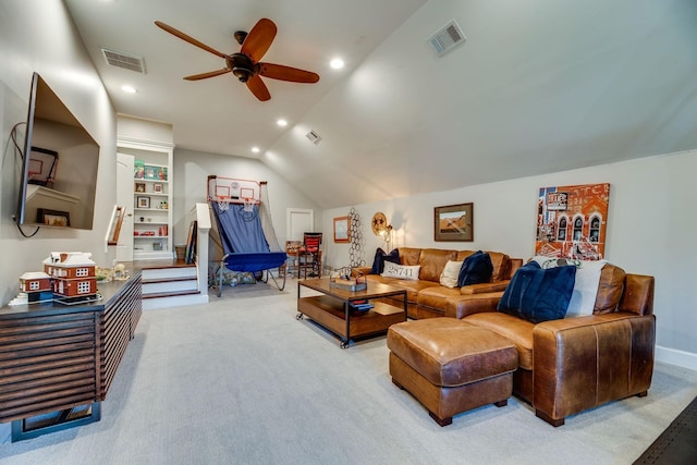 carpeted living room with ceiling fan and vaulted ceiling