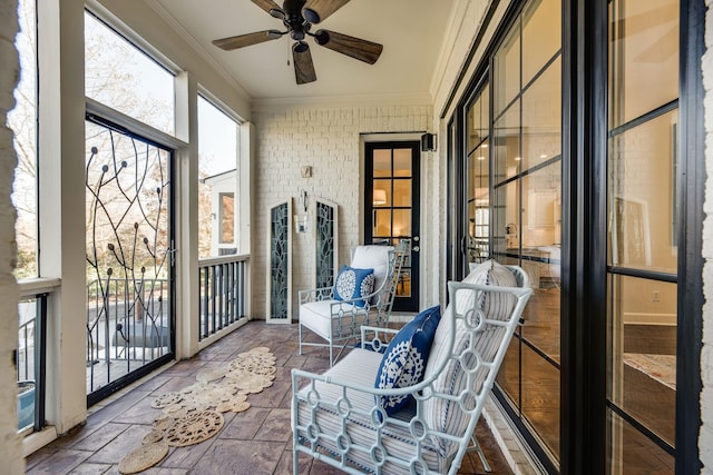 sunroom featuring ceiling fan and a wealth of natural light