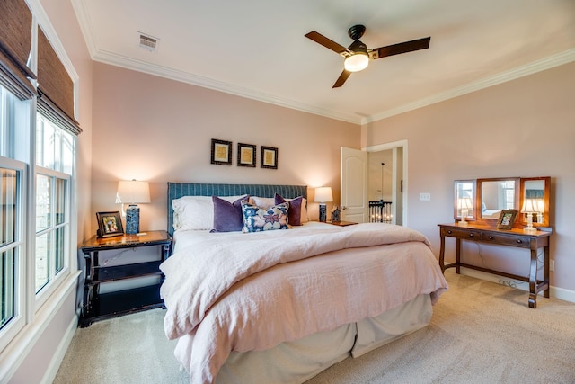 bedroom featuring ceiling fan, light colored carpet, and crown molding