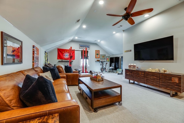 carpeted living room with ceiling fan and lofted ceiling