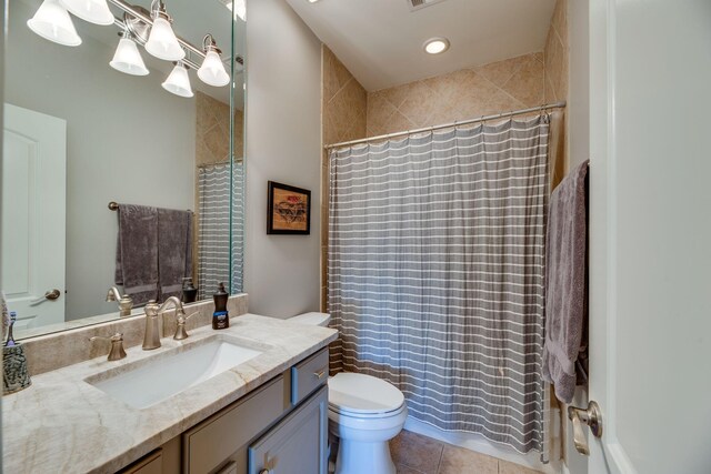 bathroom featuring toilet, tile patterned flooring, and vanity