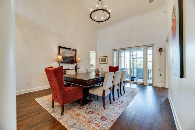 dining space with a notable chandelier, crown molding, dark hardwood / wood-style floors, and high vaulted ceiling