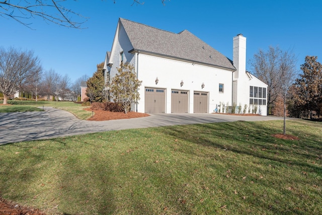 view of home's exterior with a garage and a yard