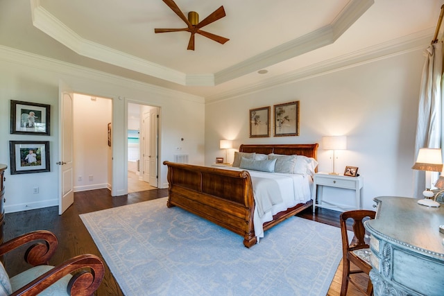 bedroom with ceiling fan, dark wood-type flooring, a tray ceiling, and crown molding