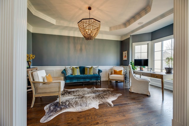 sitting room featuring an inviting chandelier, dark hardwood / wood-style flooring, crown molding, and a raised ceiling