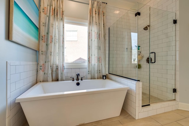 bathroom with separate shower and tub, tile walls, and tile patterned floors