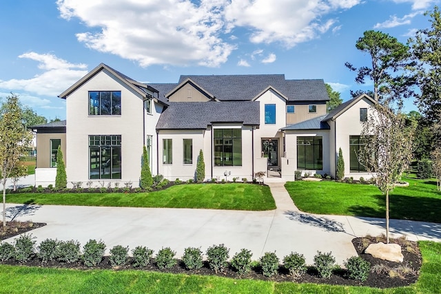 modern farmhouse style home with a front yard