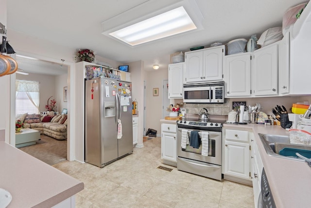 kitchen featuring sink, white cabinetry, and appliances with stainless steel finishes