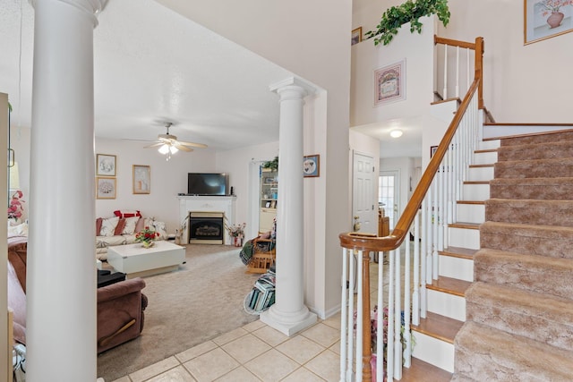 interior space featuring ceiling fan, tile patterned floors, and ornate columns