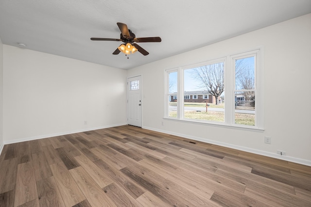 spare room with ceiling fan and hardwood / wood-style floors