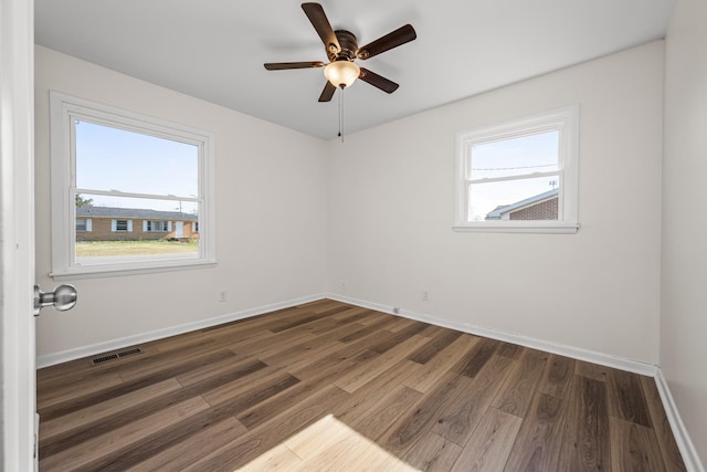 unfurnished room with ceiling fan and dark hardwood / wood-style flooring