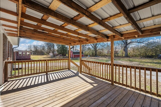 wooden deck featuring a storage unit