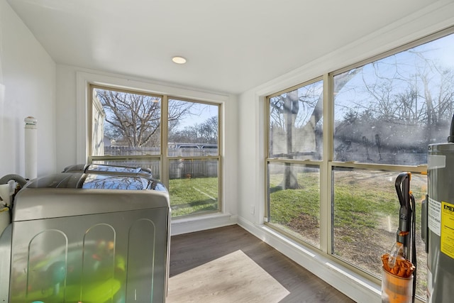 sunroom with separate washer and dryer and electric water heater