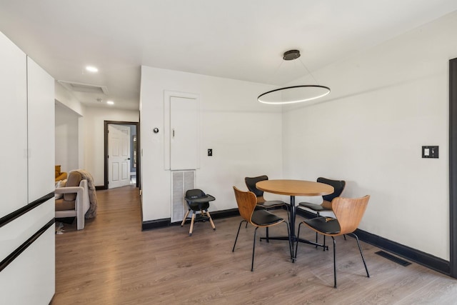 dining room with wood-type flooring