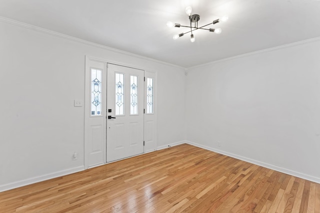 foyer with baseboards, crown molding, and light wood finished floors