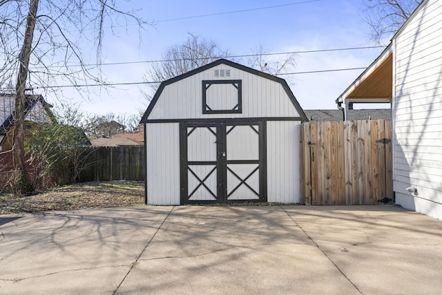 view of shed featuring fence