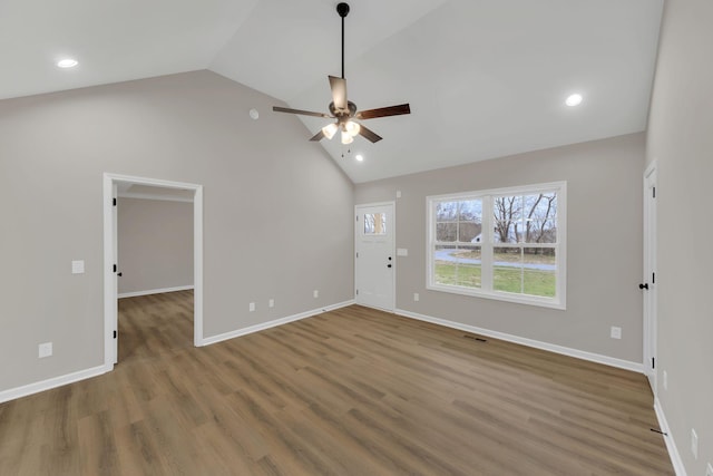 unfurnished living room with ceiling fan, lofted ceiling, and wood-type flooring