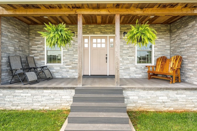 view of exterior entry with a porch