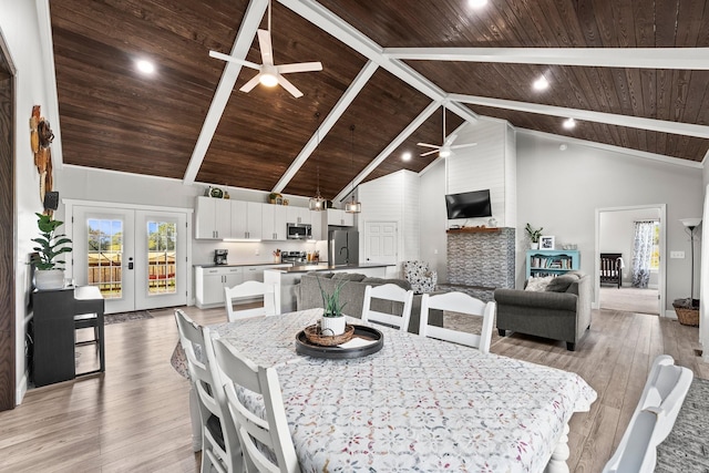 dining area featuring light wood-type flooring, wooden ceiling, french doors, and high vaulted ceiling