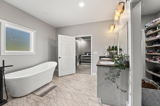 bathroom with a washtub and vanity