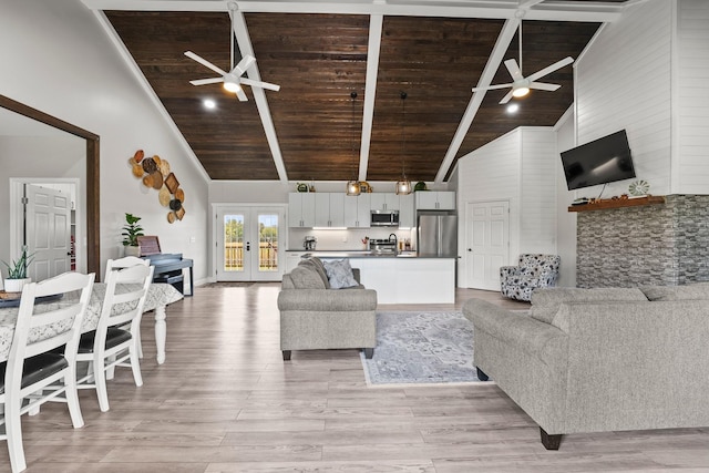 living room featuring wood ceiling, ceiling fan, light wood-type flooring, french doors, and high vaulted ceiling