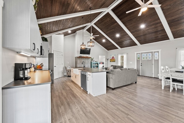 kitchen with white cabinetry, ceiling fan, hanging light fixtures, stainless steel dishwasher, and light hardwood / wood-style flooring