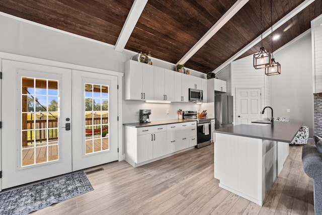 kitchen featuring hanging light fixtures, french doors, stainless steel appliances, and white cabinetry