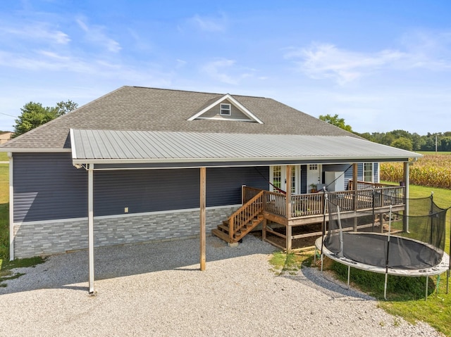 farmhouse with a trampoline and a wooden deck