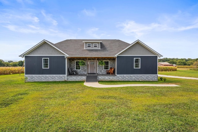 craftsman inspired home with a porch and a front yard