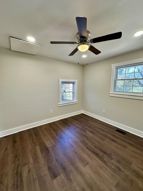 empty room with ceiling fan and dark hardwood / wood-style floors