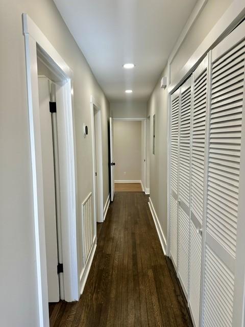 hall with dark wood-type flooring