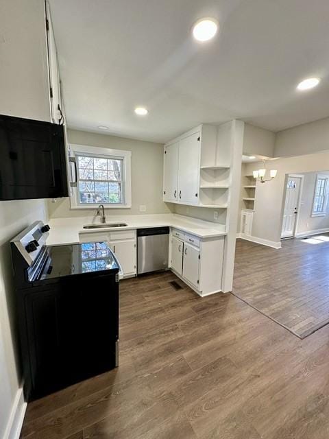 kitchen with white cabinets, sink, a notable chandelier, hardwood / wood-style flooring, and stainless steel dishwasher