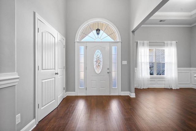 foyer entrance featuring dark wood-type flooring and crown molding