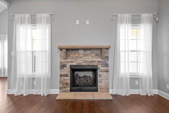 details featuring a stone fireplace and hardwood / wood-style floors