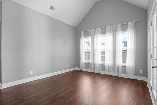 unfurnished room featuring dark hardwood / wood-style floors and vaulted ceiling