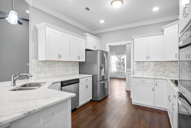 kitchen with sink, ornamental molding, white cabinetry, and stainless steel appliances